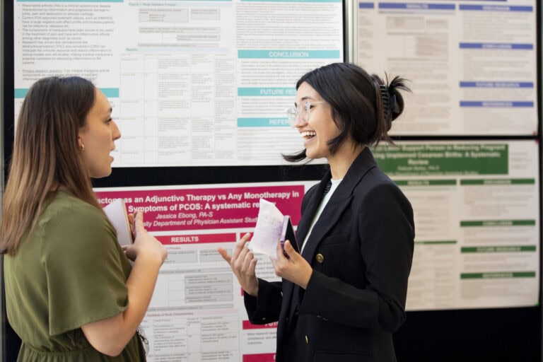 A student presents her work at the Research Symposium