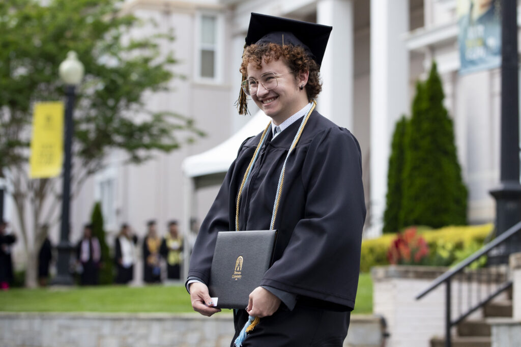 Lucius Gardner smiles after getting his diploma