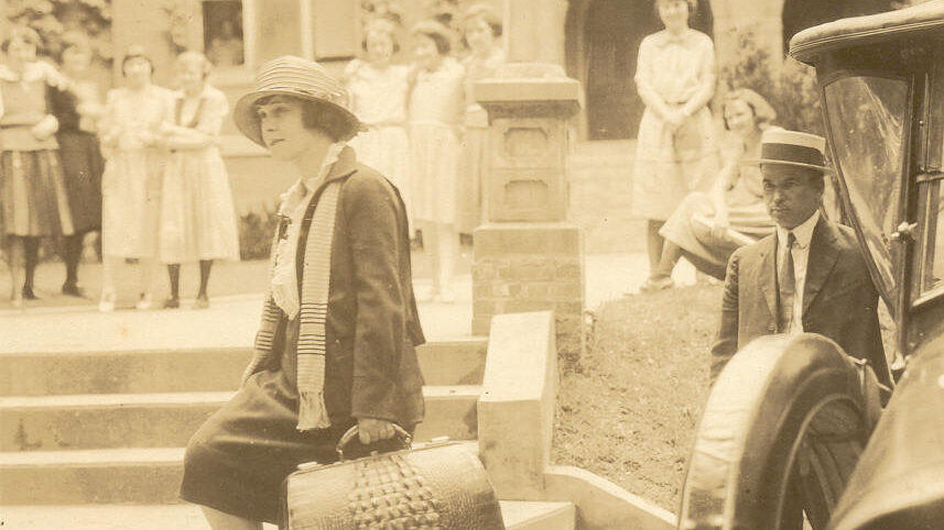 A young woman exits a car on Brenau's campus, circa 1920s
