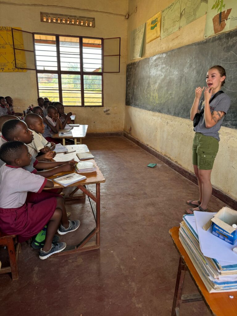 A female Brenau student teaches Rwandan students as part of a record number of global experiences in 2023-24