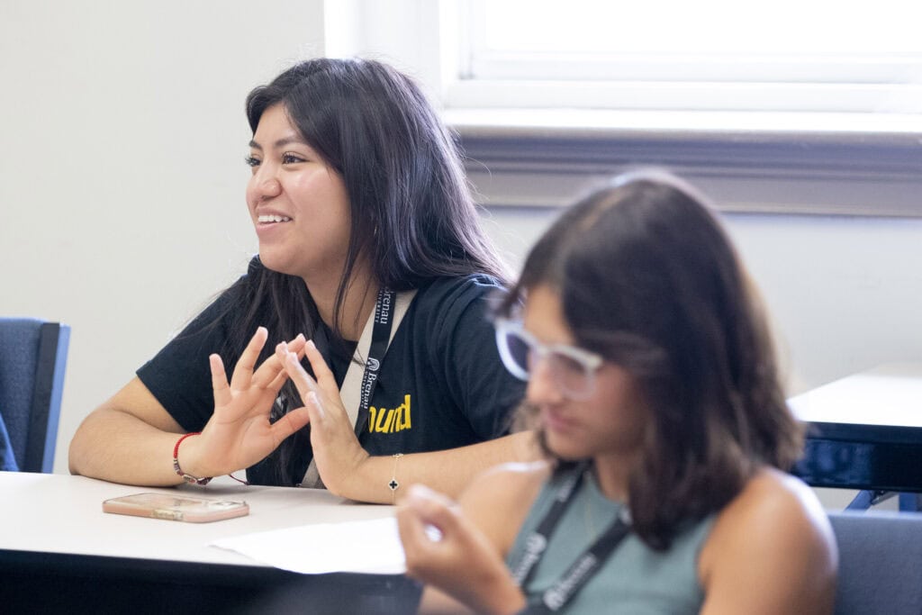 A female student joins in a group discussion