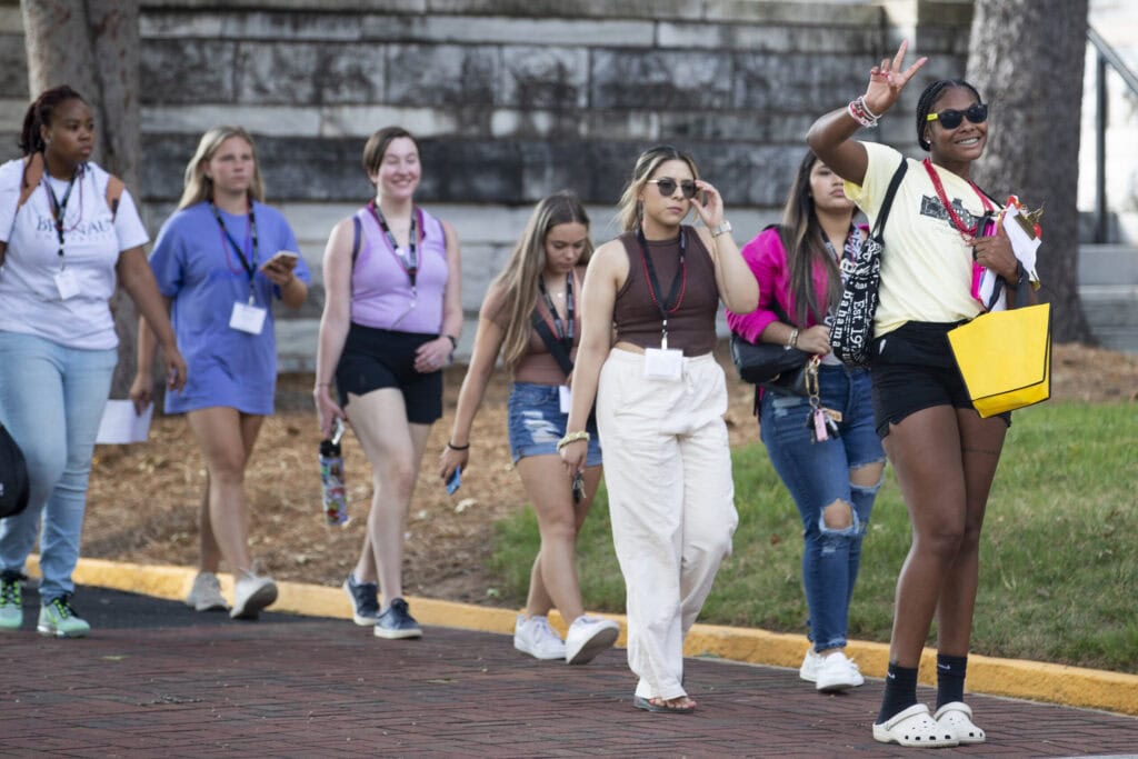 A group of students are led to their next event by a student leader