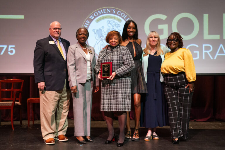 Michelle Gray Haywood poses with award and admins