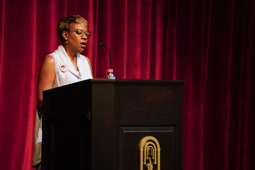 Philippa Lewis Moss speaks at a podium