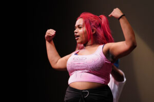A dancer poses in a power pose