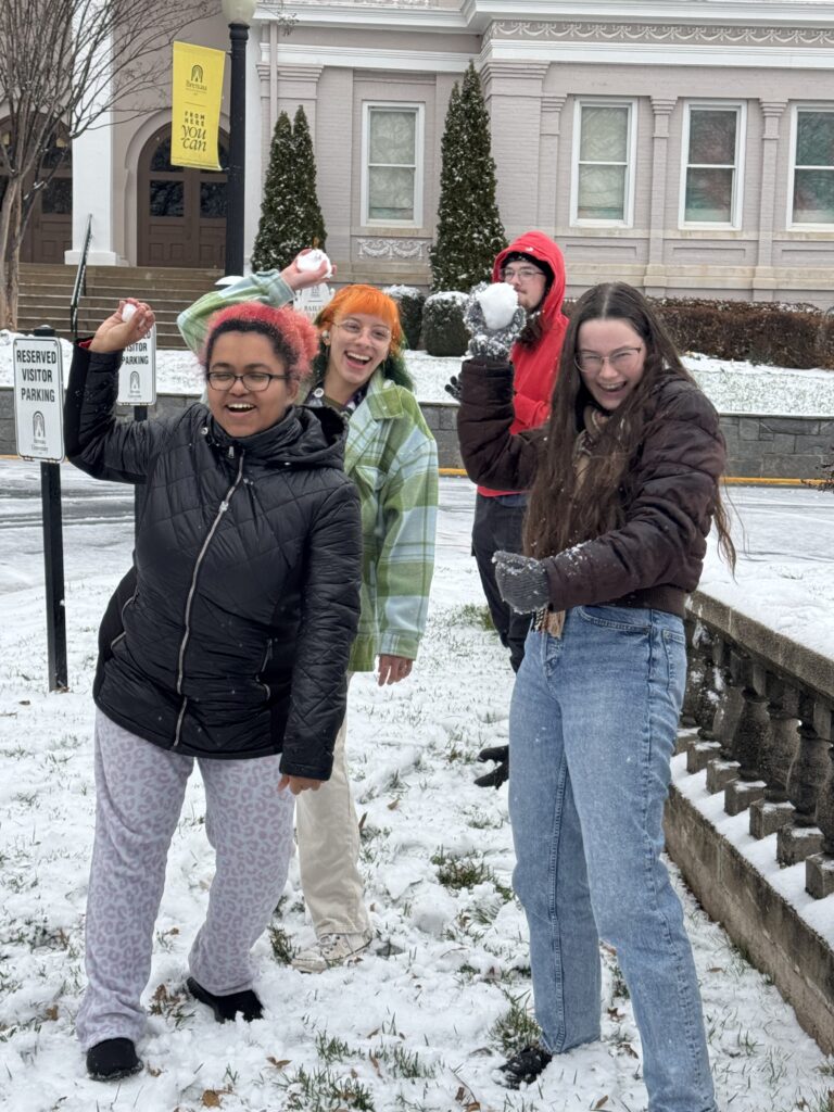 students throwing snowballs