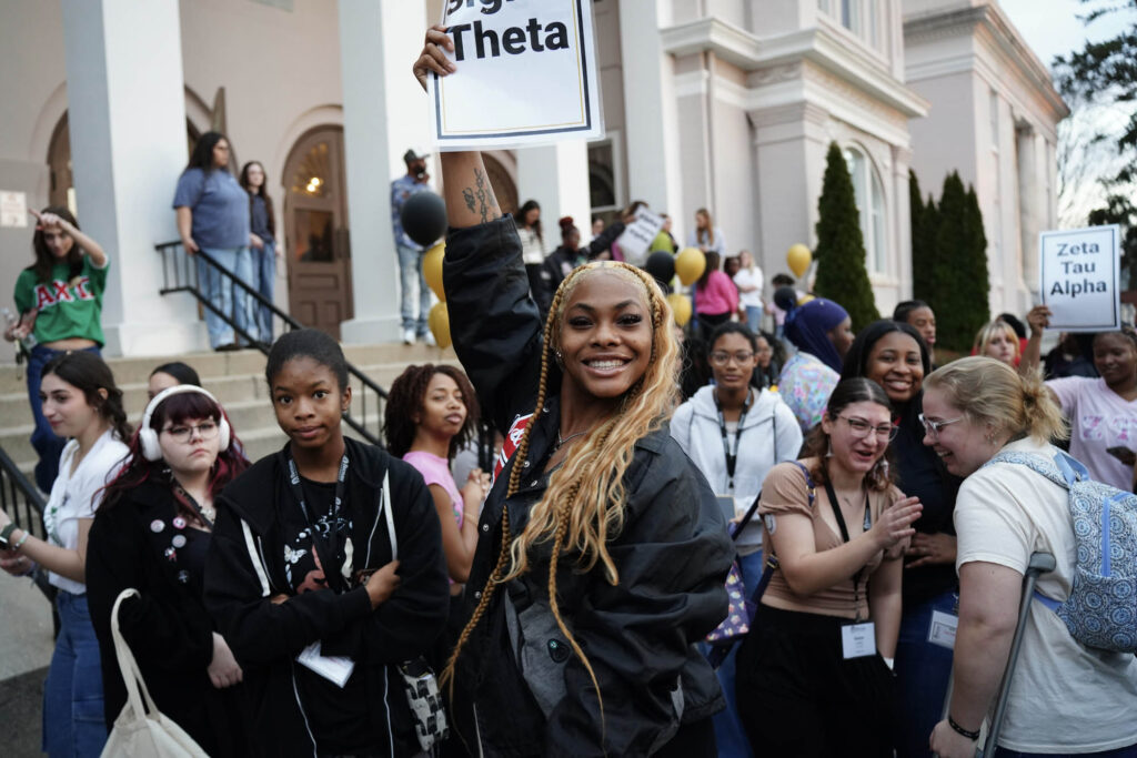 Student group leader holding up a sign