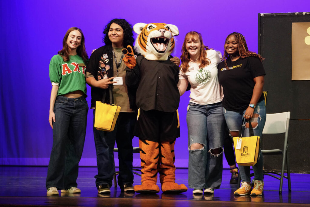 HJ posing with students during the Brenau's got talent