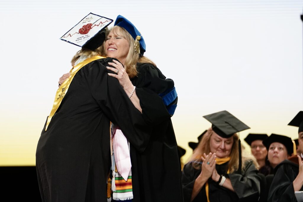 Dr. Dobkins hugs a Women's College student