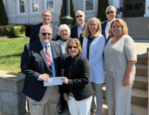 Breanu admin and the Leitalift Foundation with check
