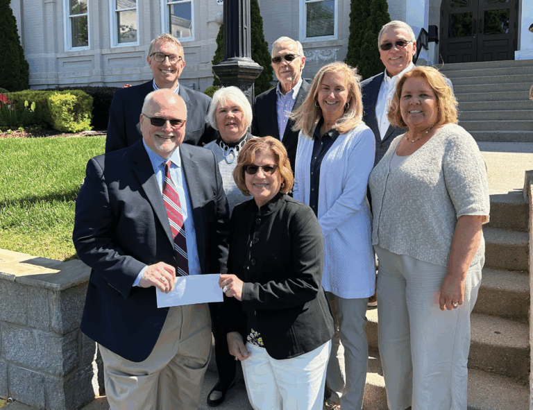 Breanu admin and the Leitalift Foundation with check