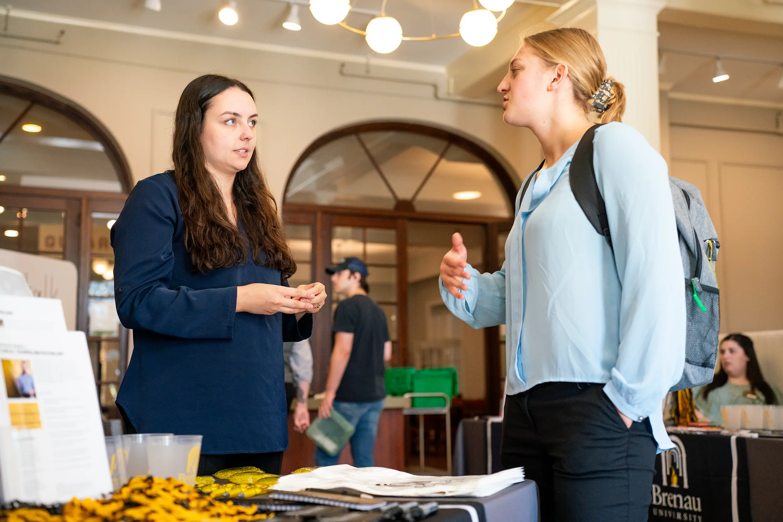 Admissions counselor talking to international student