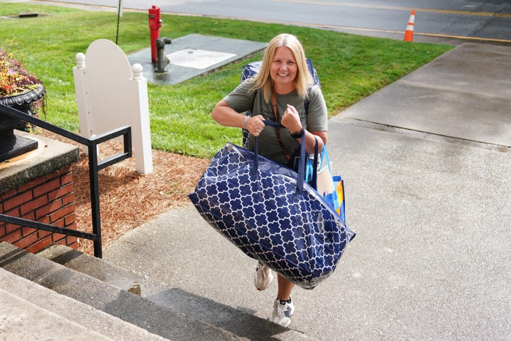 a new student brings her matching luggage into the dorm