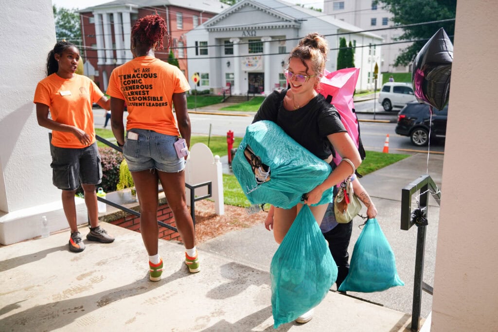 returning student leaders on the porch as students bring it personal items