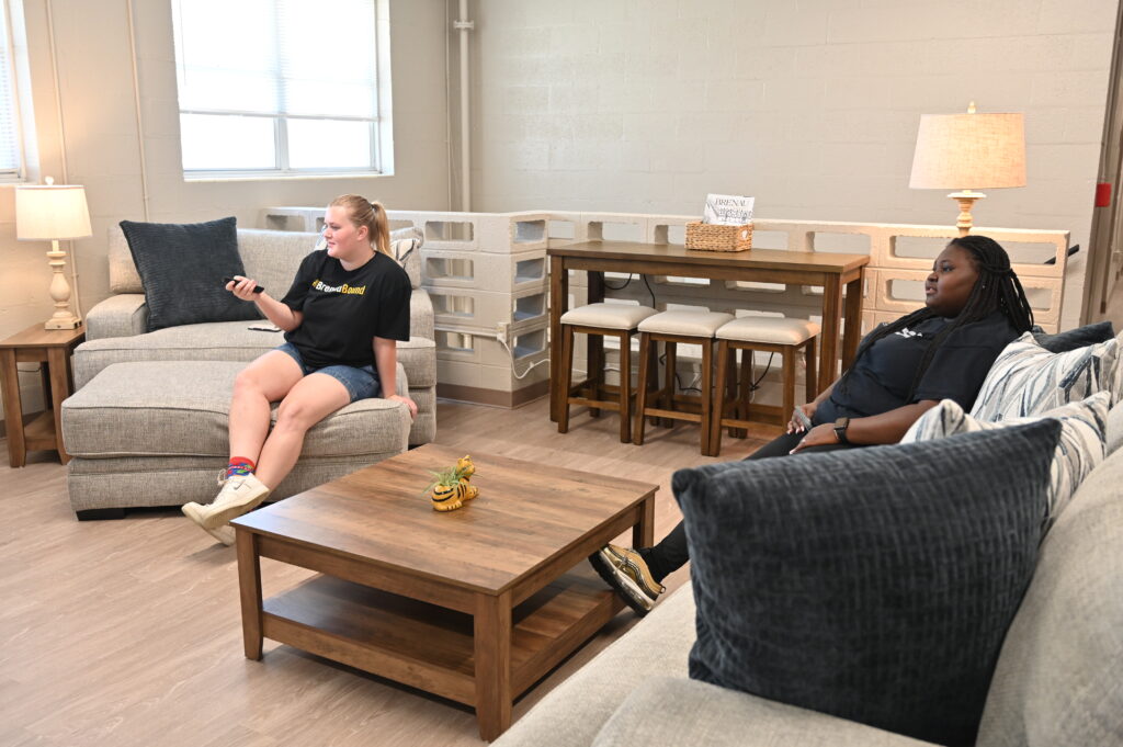 Student ambassadors Clover and Mercedes use the TV in the lounge.