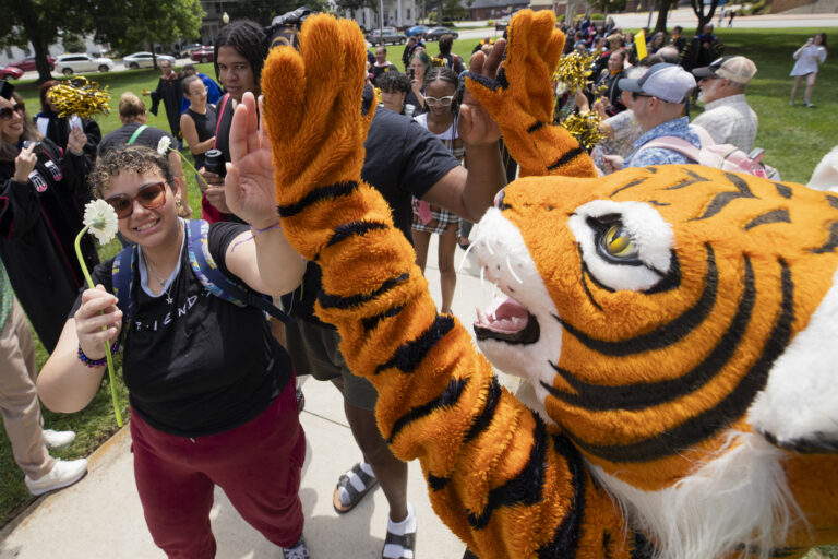 HJ high fives a new student