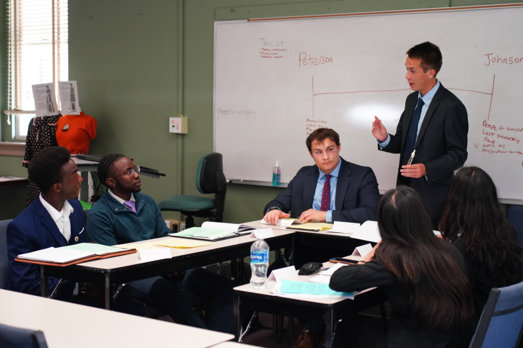 six students at tabls during the mediation tournament