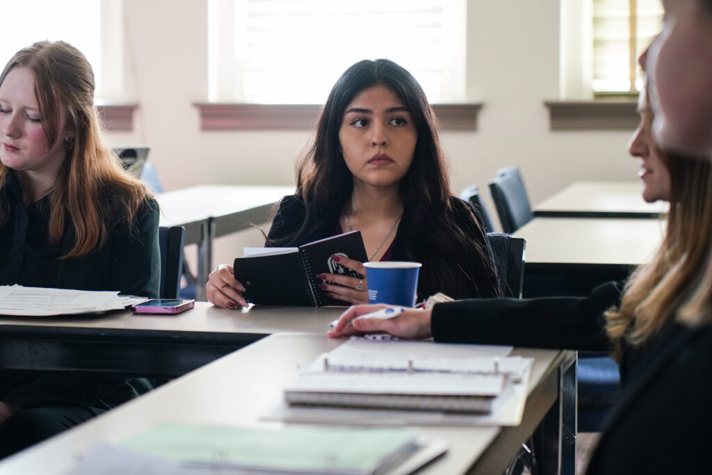 a brenau student holds a notebook