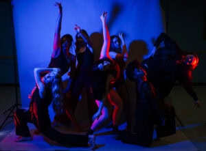 brenau dance students pose in front of backdrop