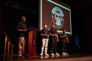 Tiger Power Hour event at Brenau University featuring students on stage with university logo in the background.