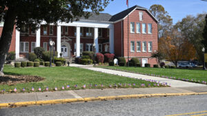 American flags decorating a sidewalk leading to Brenau University building in Georgia, showcasing campus pride and patriotic spirit.