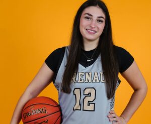 Brenau basketball player holds basketball