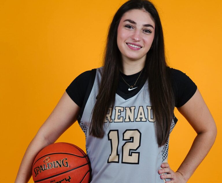Brenau basketball player holds basketball