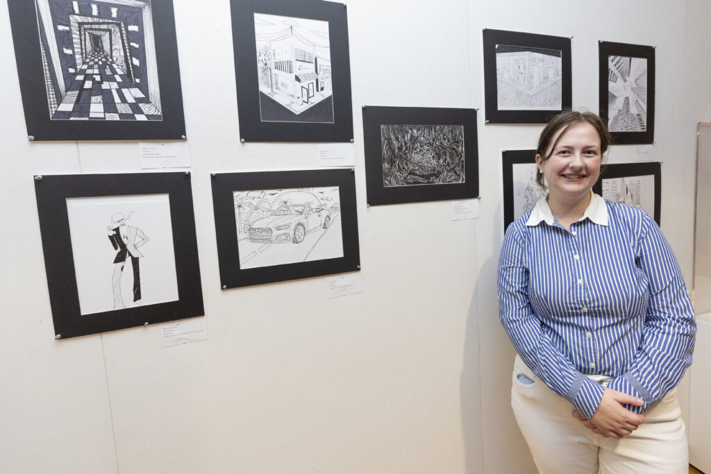 a student with her ink drawings