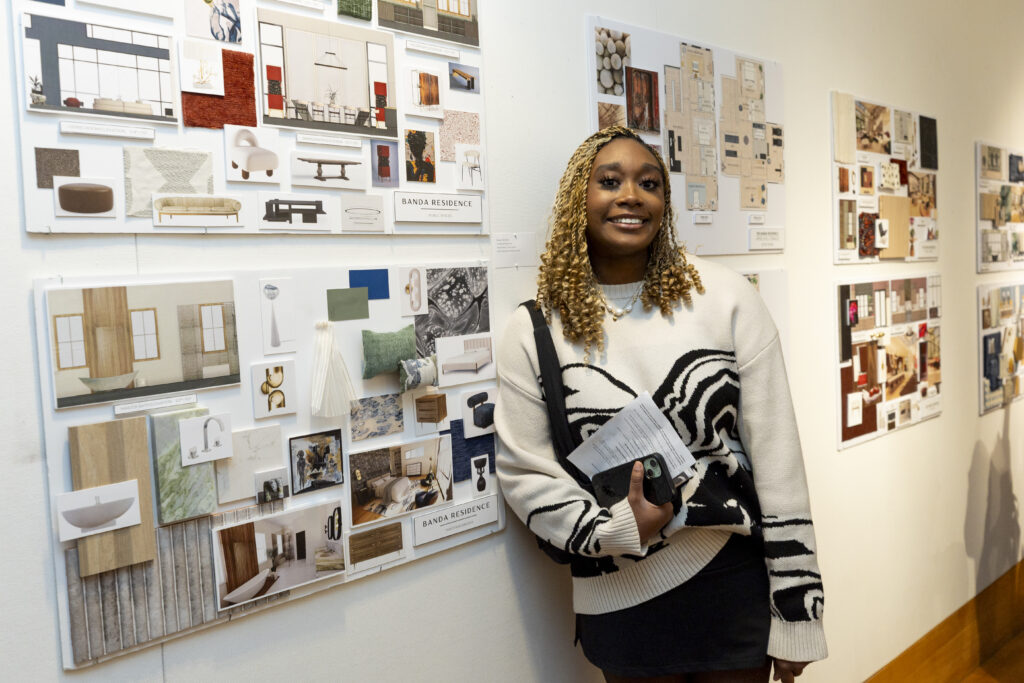 a student with her interior design board