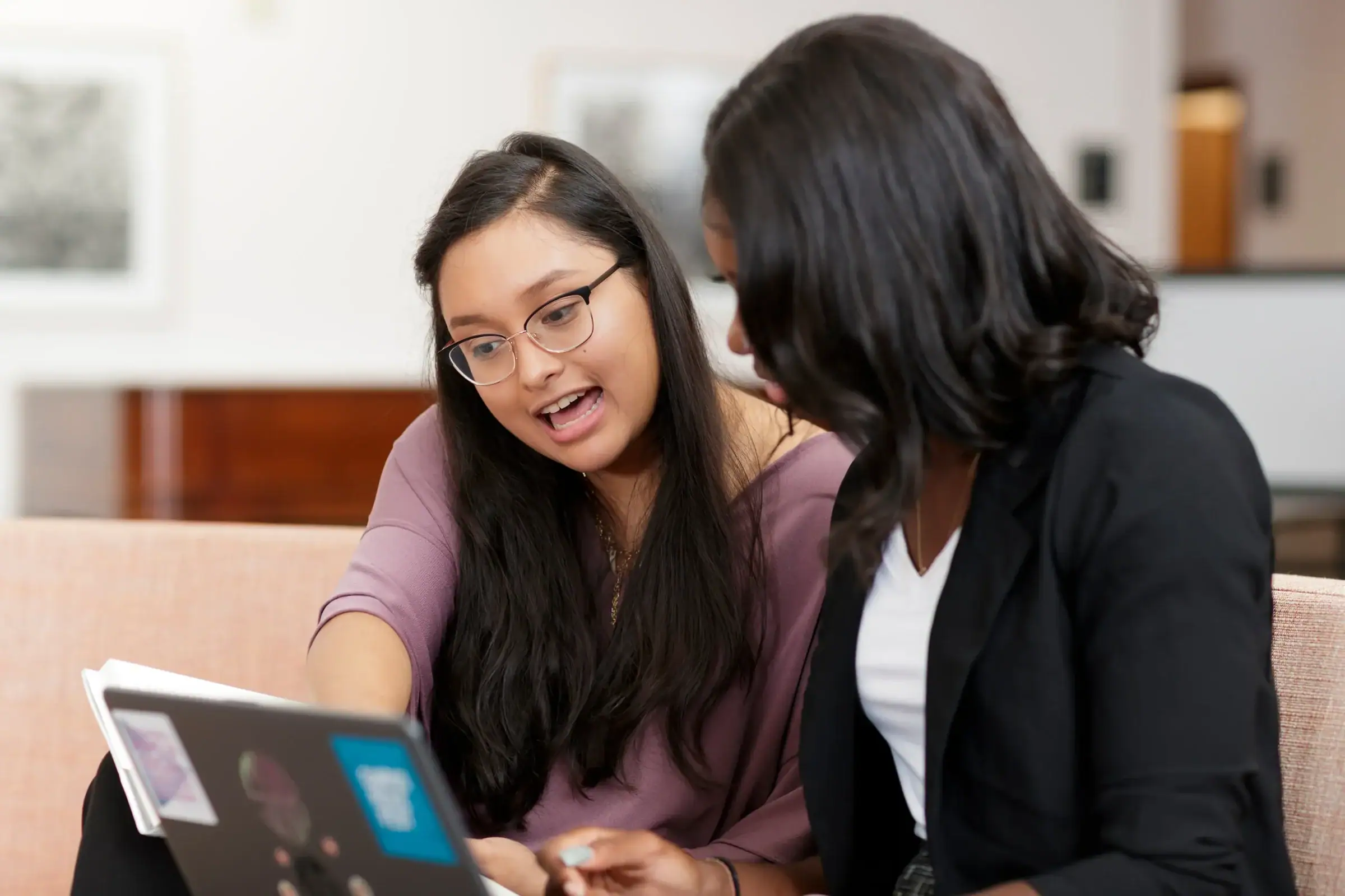 Students talk over laptop