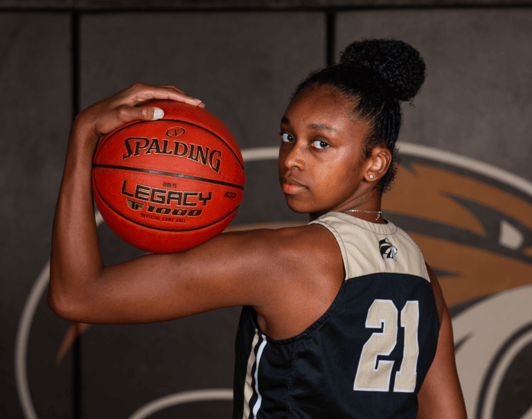 caylie long serious pose with basketball on bicep