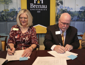 two university presidents sign agreements