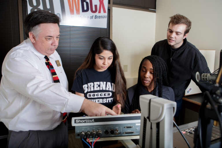 students and instructor in a radio station studio