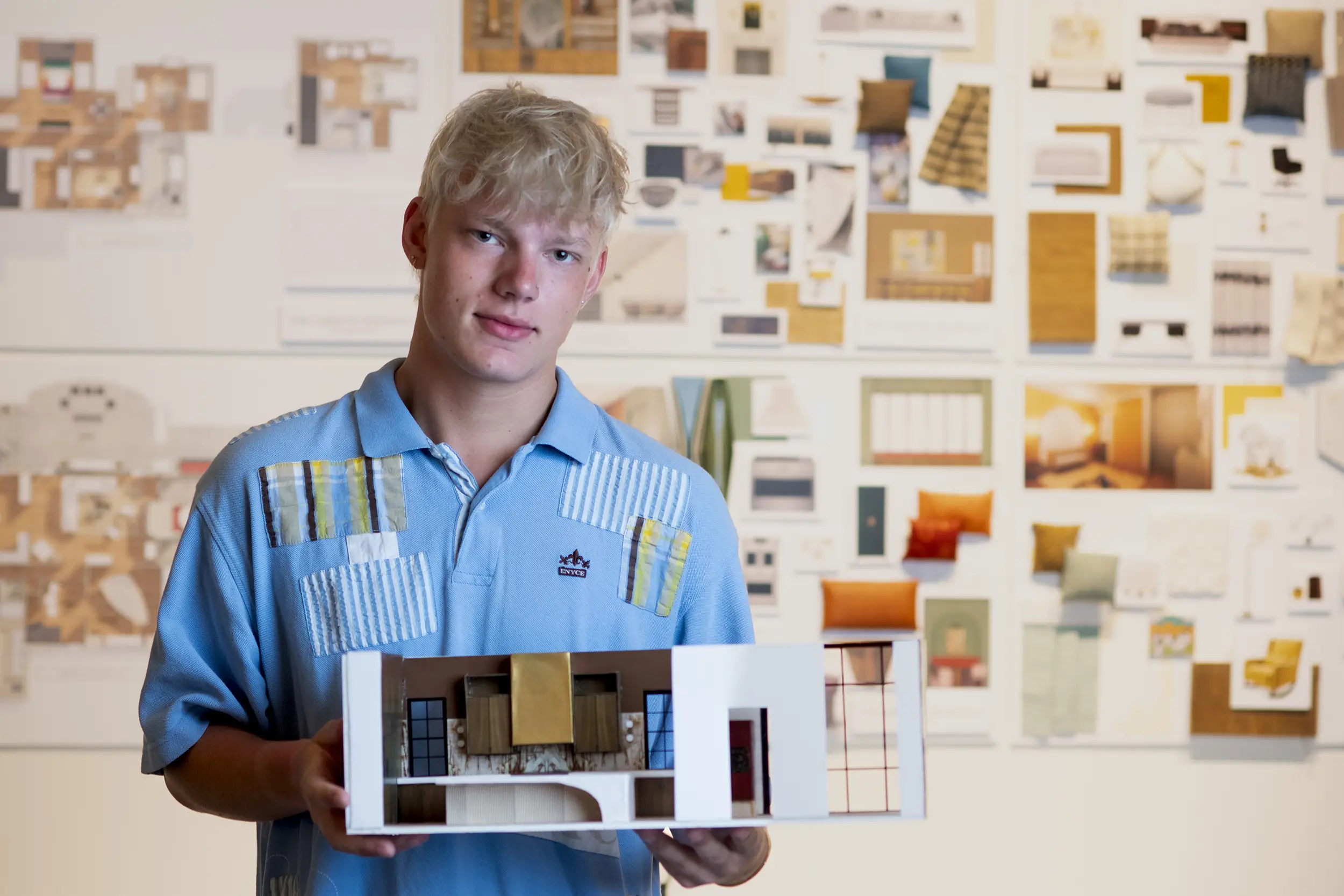 Interior Design student holds diorama.