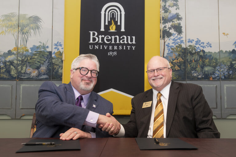Breanau President David Barnett (right) shaking hands with Young Harris president, John Wells.