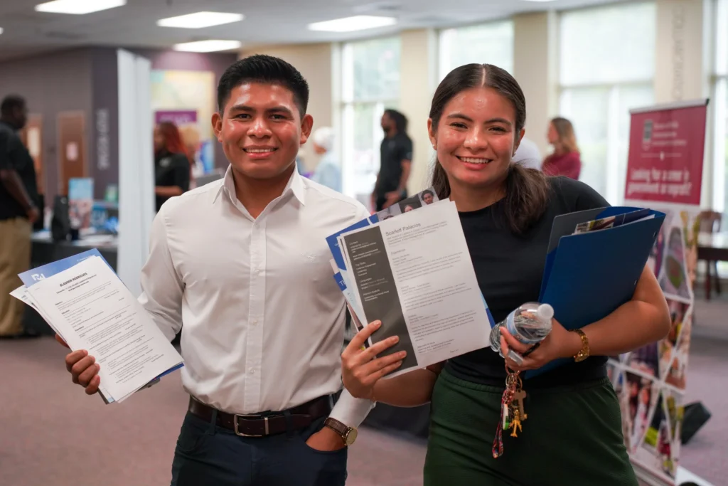 Two students attend a career fair and resume workshop