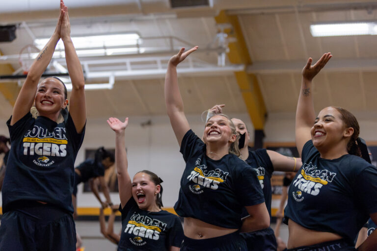 Brenau cheerleaders waving during annual Pep Rally.